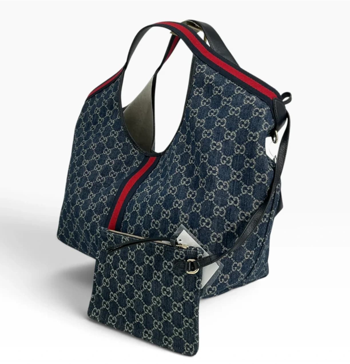 A denim Gucci bag with its matching pouch